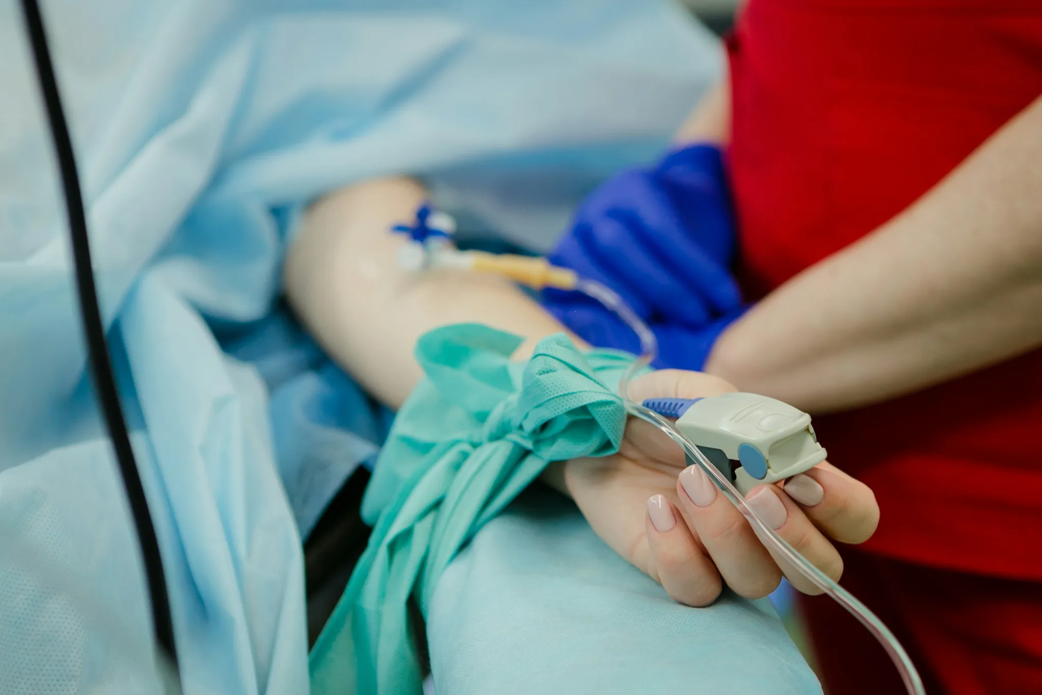 Nurse checking a patient's oxygen level at the bedside