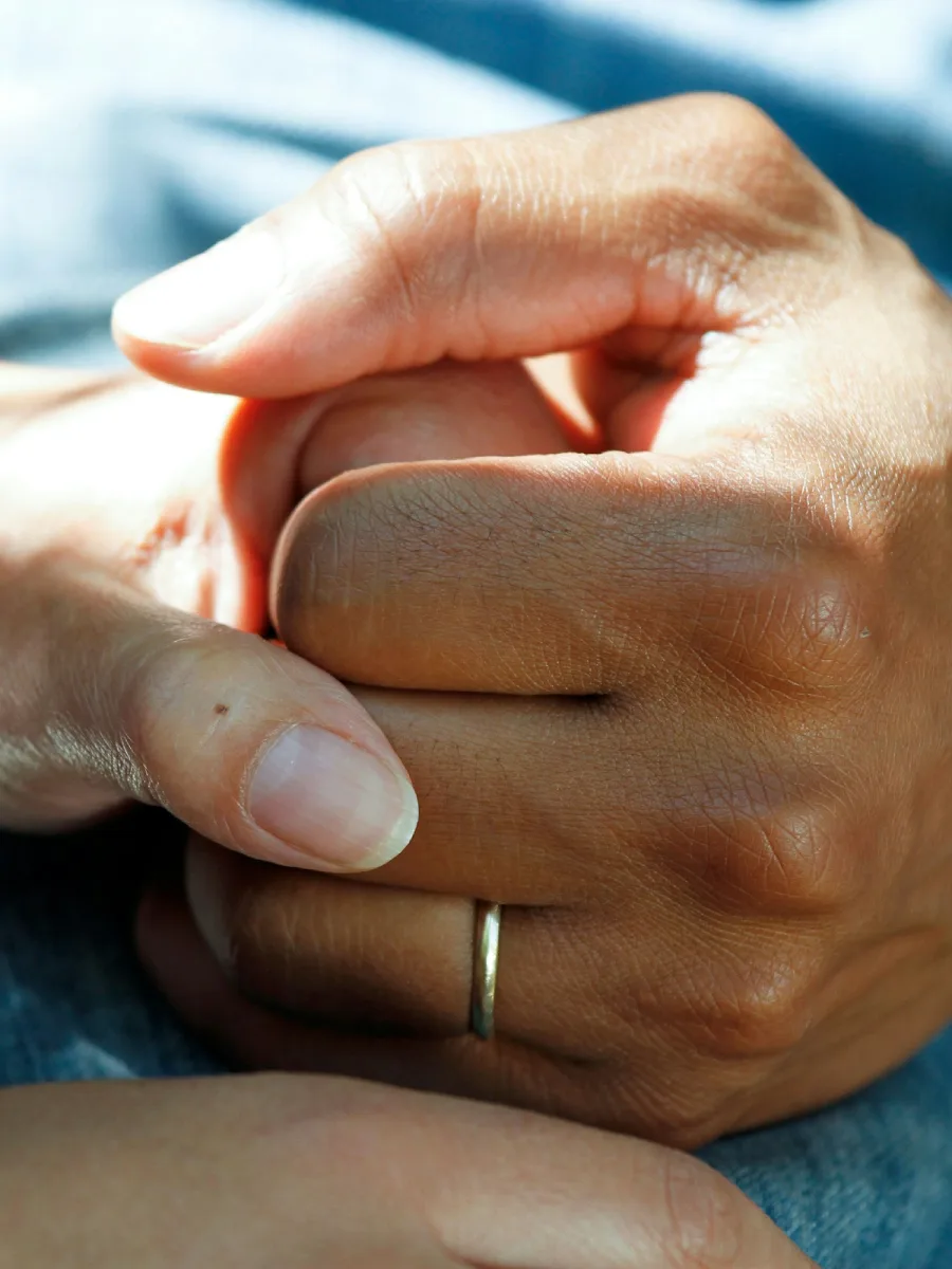 Caregiver holding a patient's hands