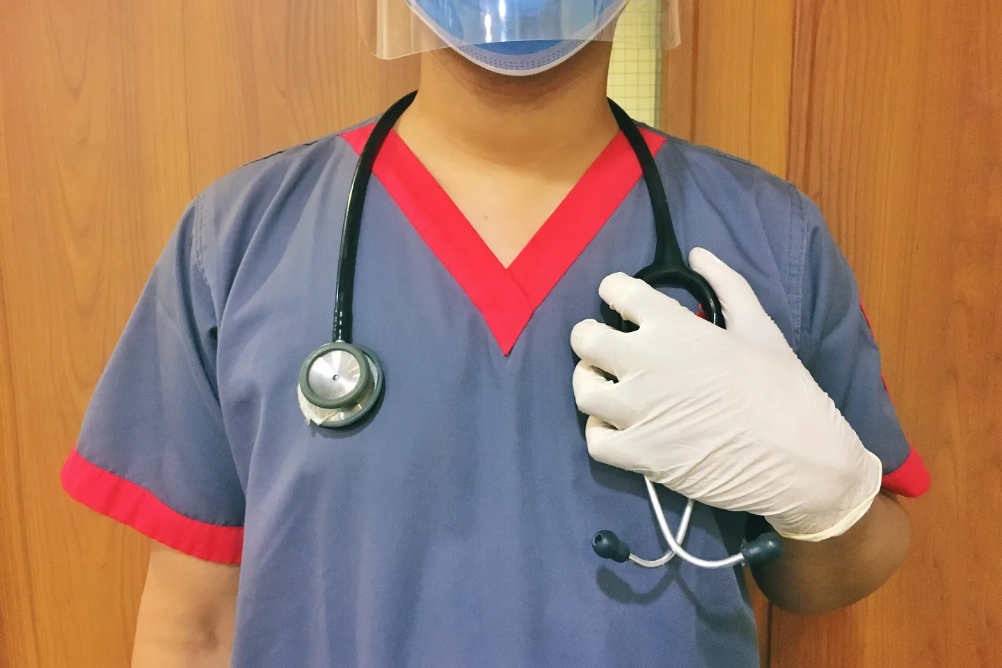 Clinician in a mask and gloves for infection control