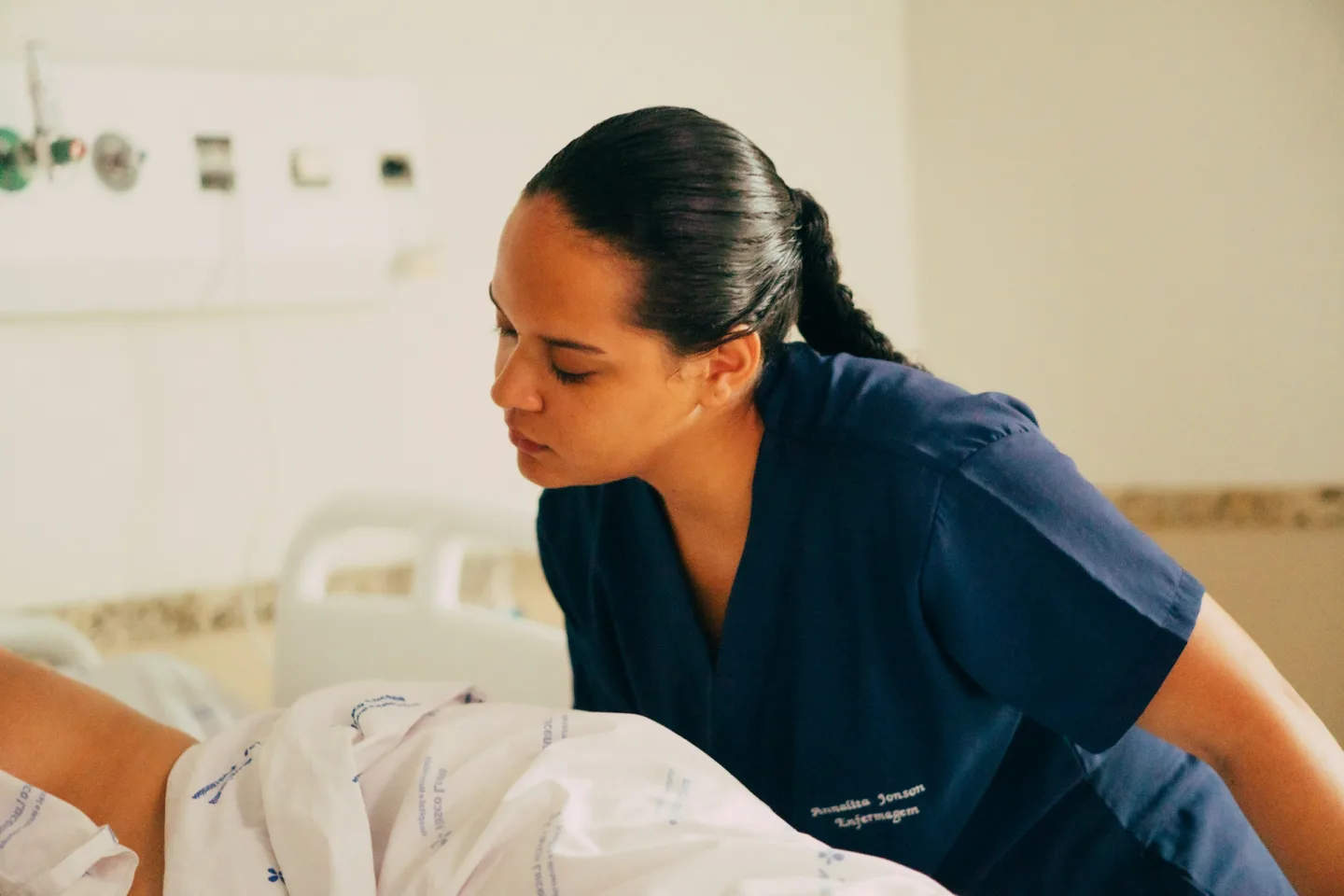 Nurse attending to a patient in bed