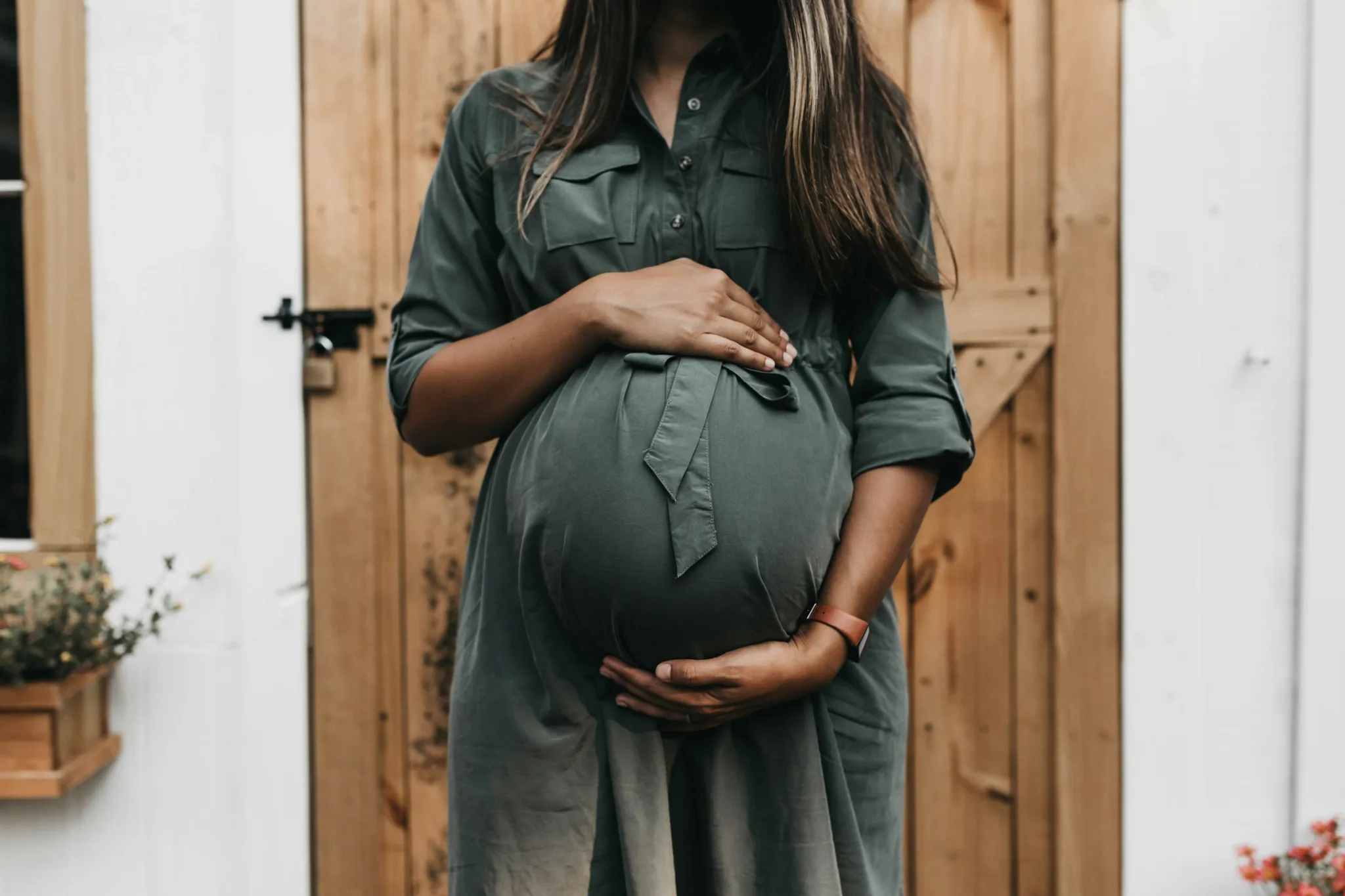 Expectant mother in a modest dress